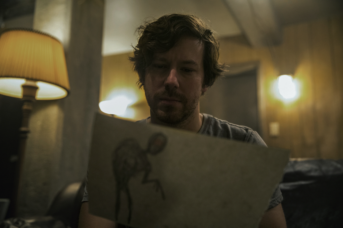 John Gallagher Jr. as "Marty" in writer/director Jacob Chase's COME PLAY. Credit : Jasper Savage / Amblin Partners / Focus Features
