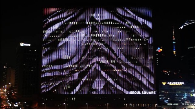 From the documentation video for "scrape" a work projected on the side of a building in Seoul. 